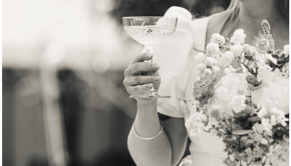 Whimsical Tuscan-Inspired Wedding in Hampshire | A bride holding champagne couple and bridal bouquet