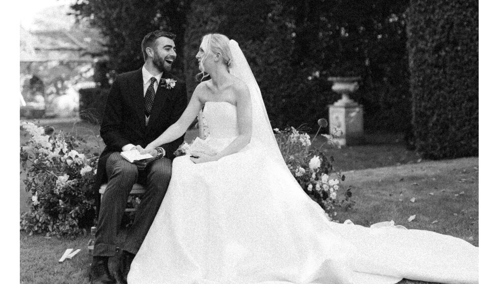 Bride and groom exchange glances during Hampshire's country garden ceremony.