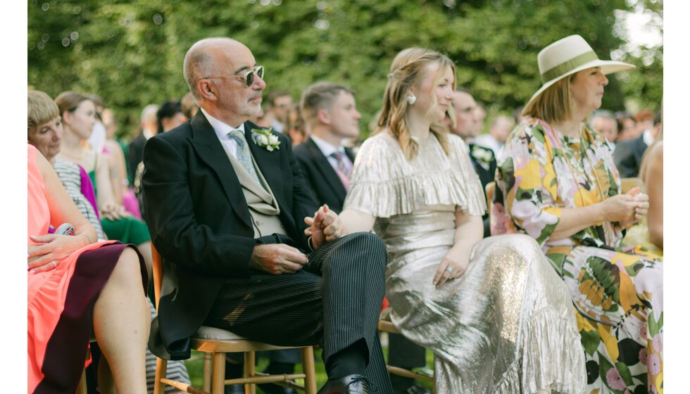 Wedding guests watching the country house wedding ceremony in Hampshire