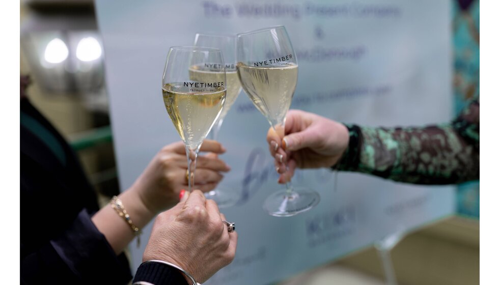 Toasting with flutes with Nyetimber English sparkling wine outside The Wedding Present Company showroom