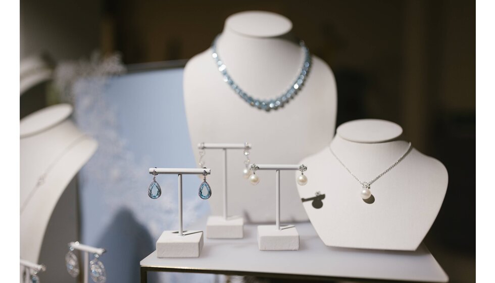 A showcase of pastel blue Kiki McDonough jewellery in The Wedding Present Company showroom