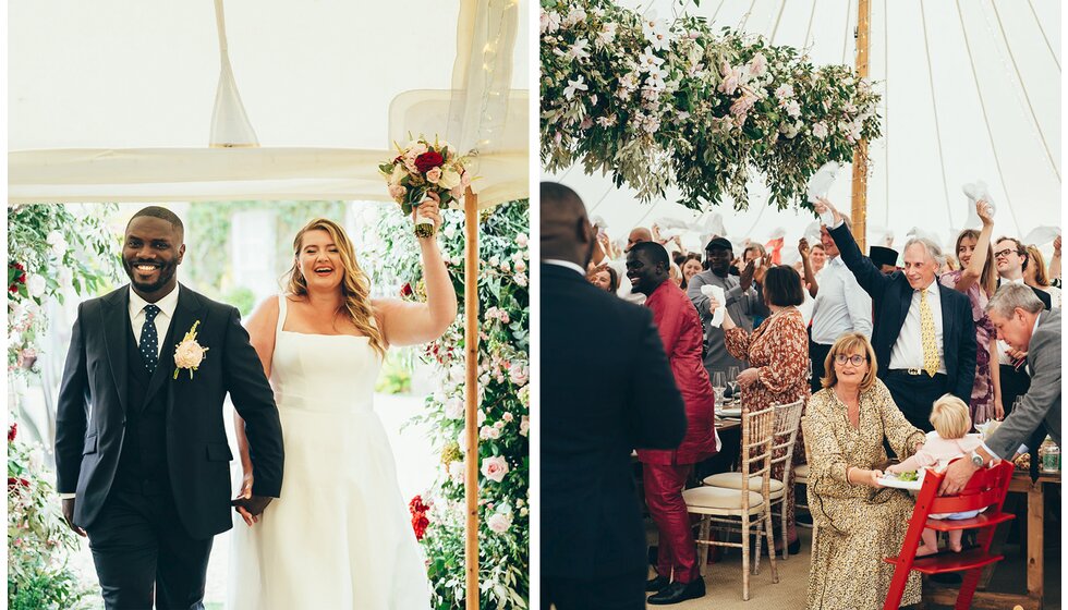 The bride and groom arrive at their wedding dinner at the marquee while being cheered by their guests.