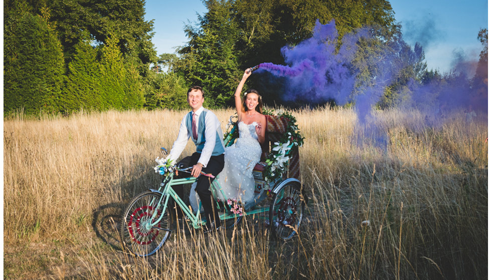 Charlie cycling Daisy back from the Church to the marquee on a rickshaw.