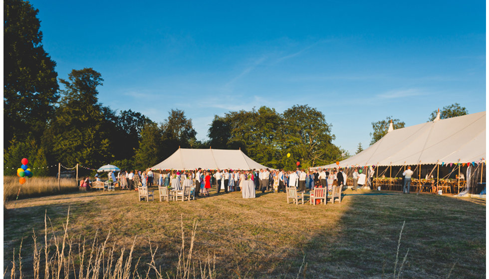 Daisy and Charlie's traditional marquees decorated with lots of colourful bunting and festoon lighting