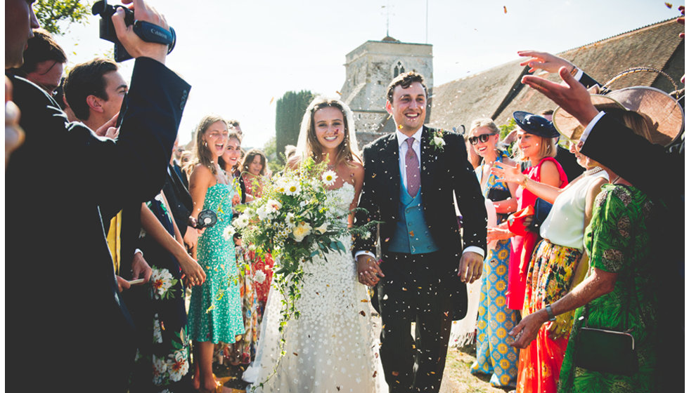 Charlie and Daisy come out of the church alongside all of their guests.