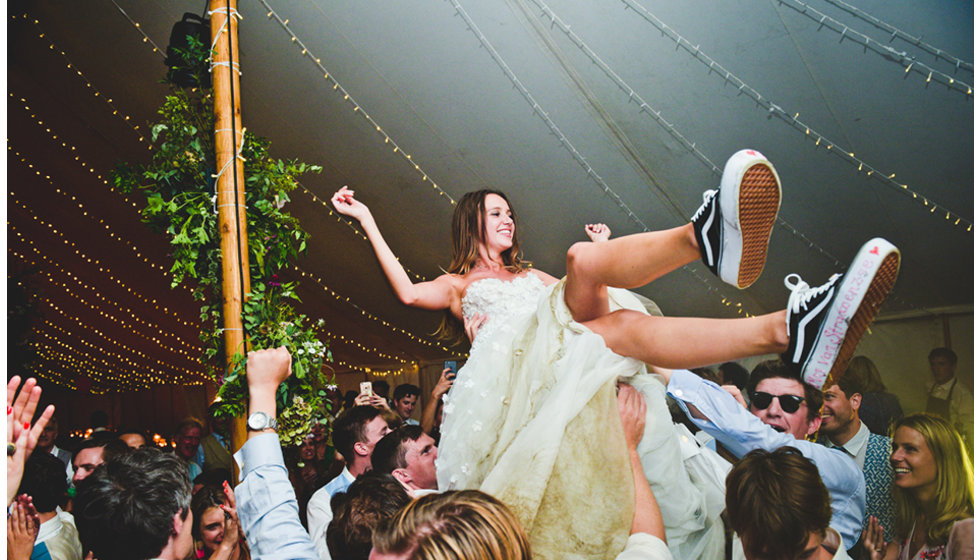 Daisy shows off her vans whilst being lifted above the crowd during the live music.