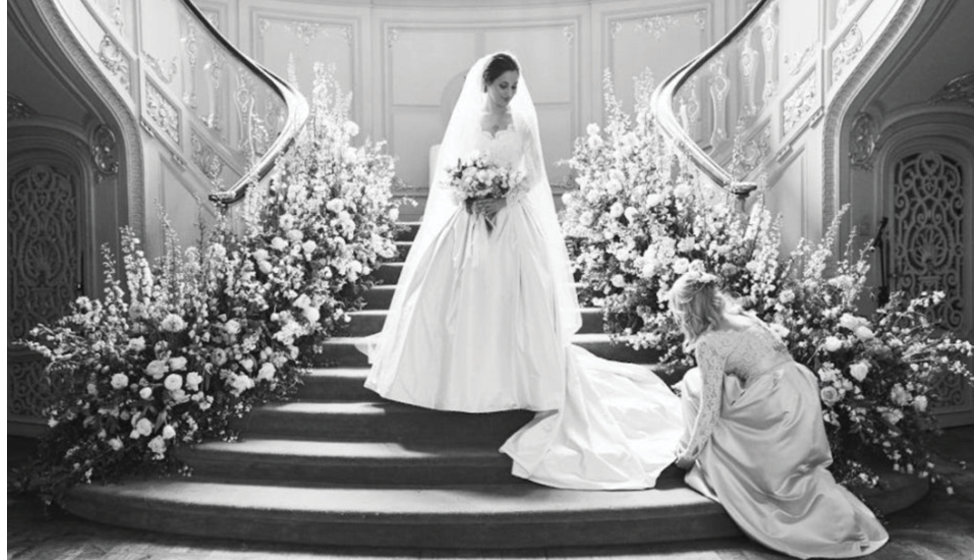 Daisy's bridesmaid adjusting helping the bride with her dress