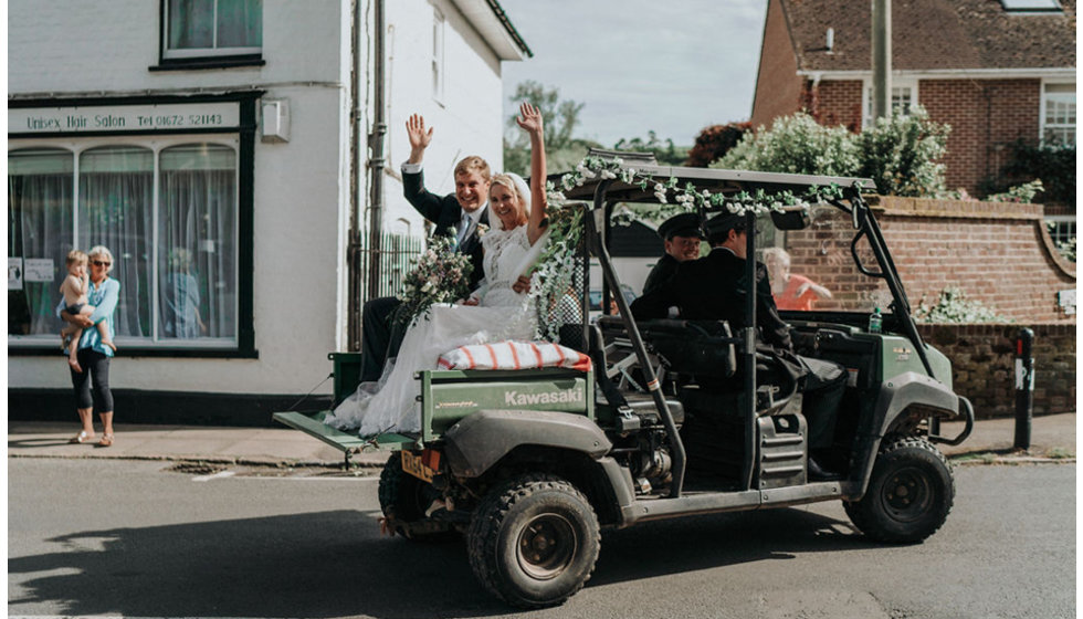 Ed and Harriet being transported to their reception by the ushers in chauffeur hats. 