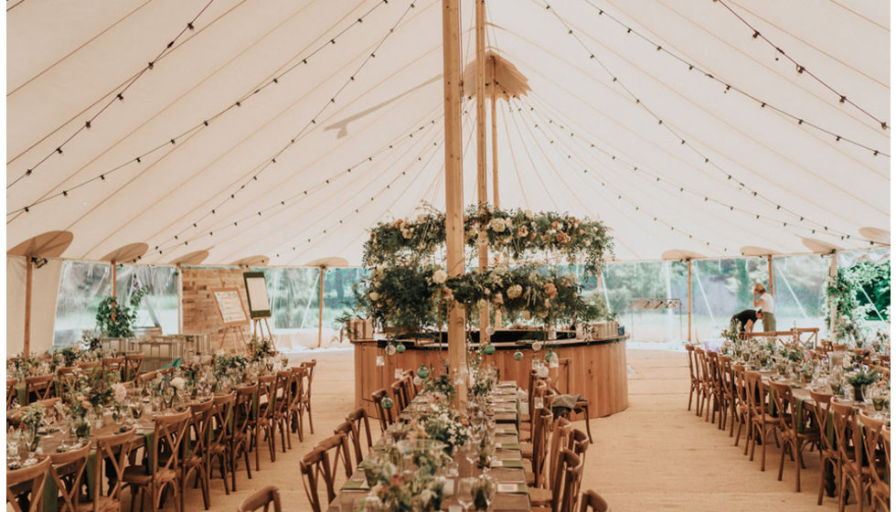 The tables in the marquee all ready for the wedding reception.