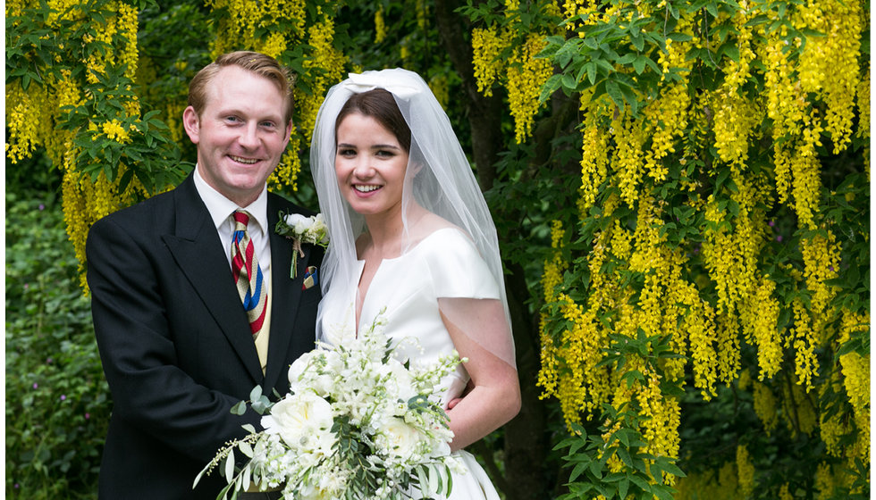 Min and Duncan posing in the garden before their reception. 