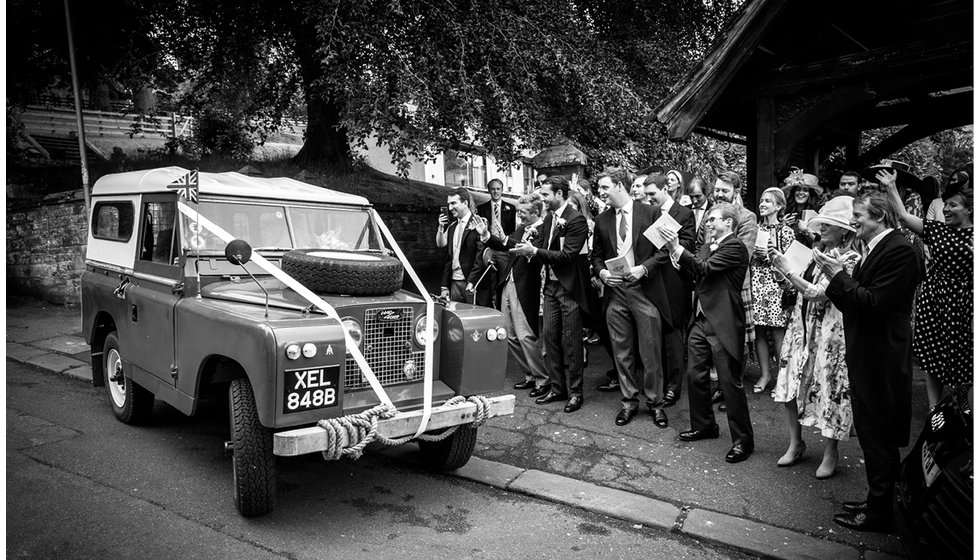 The couple's wedding transport - a decorated Land Rover. 