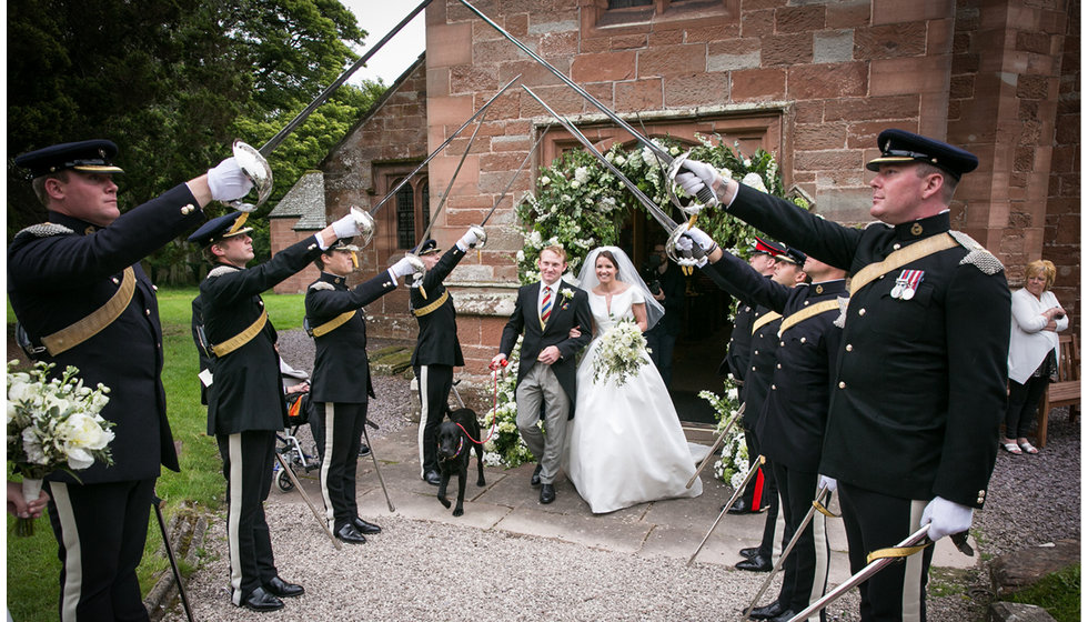 Min and Duncan come out of the Church with their labrador.