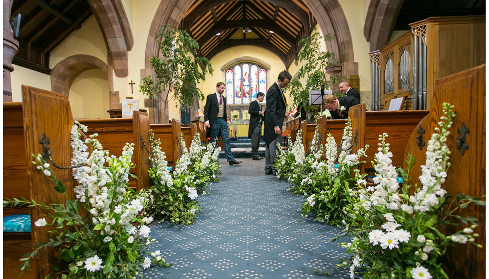 The flowers in the Church decorating the aisles. 