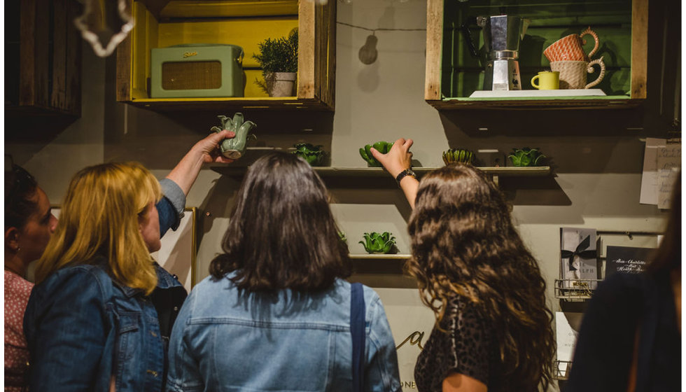 Attendees looking at tea-light holders by OKA.