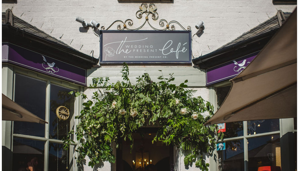 The front of the Nest Cafe taken over by The Wedding Present Co. with new signage and a flower arch.