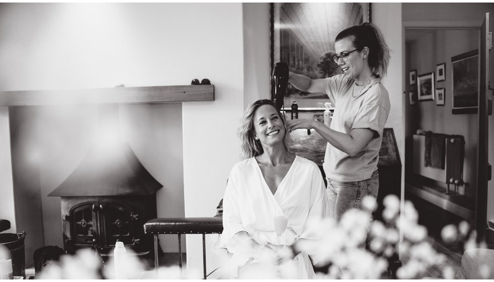 Bride Poppy has her hair done on the morning of her wedding