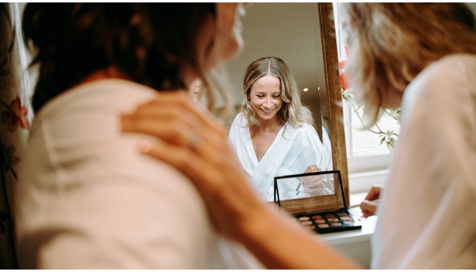 Bride Poppy helps her bridesmaid with her make up