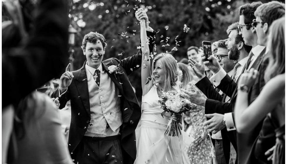 Black and white image of Jo and Sam coming out of the church.