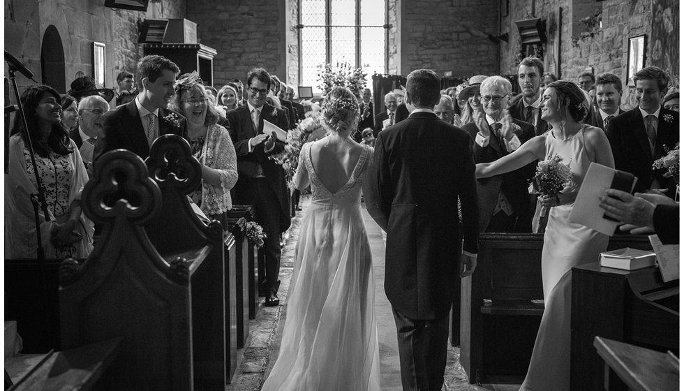 The bride and groom walking down the aisle.