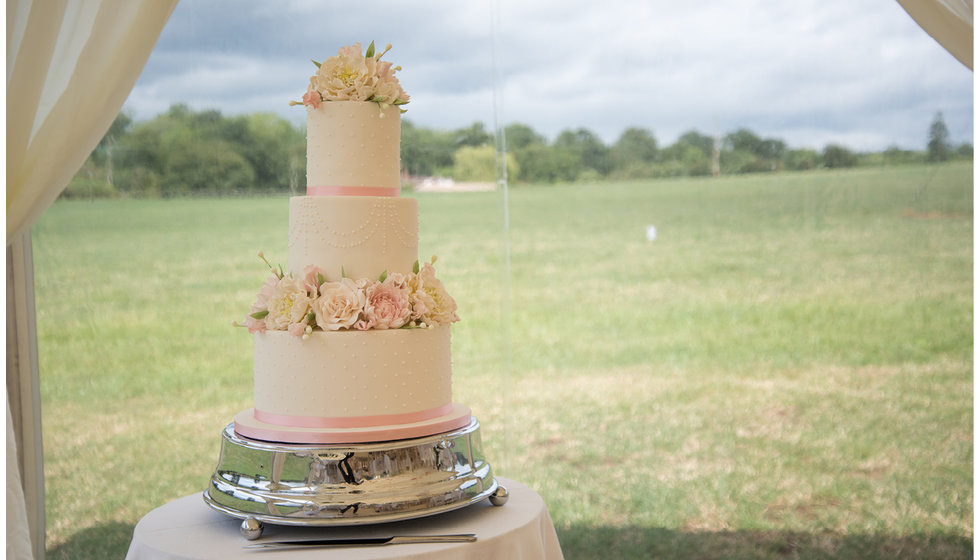 The bride and grooms cake decorated with flowers from the mothers garden.