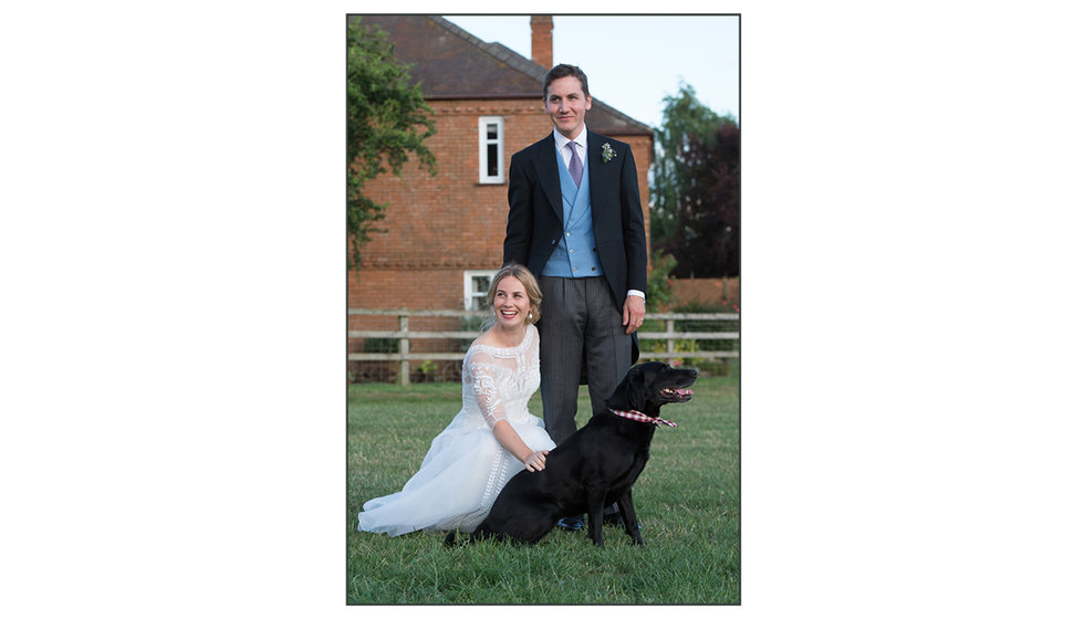 Ian and Lizzie pose outside with their labrador.