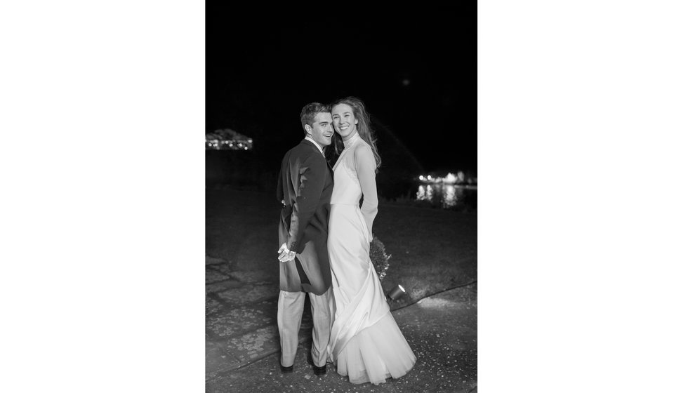 The bride and groom outside together.