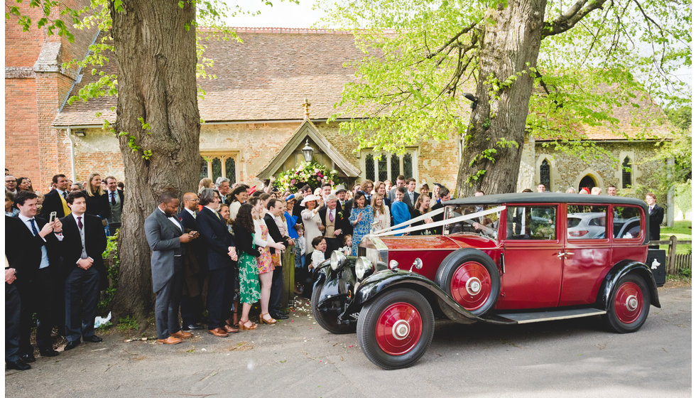 The car outside the Church waiting to drive the bride and groom to the reception.