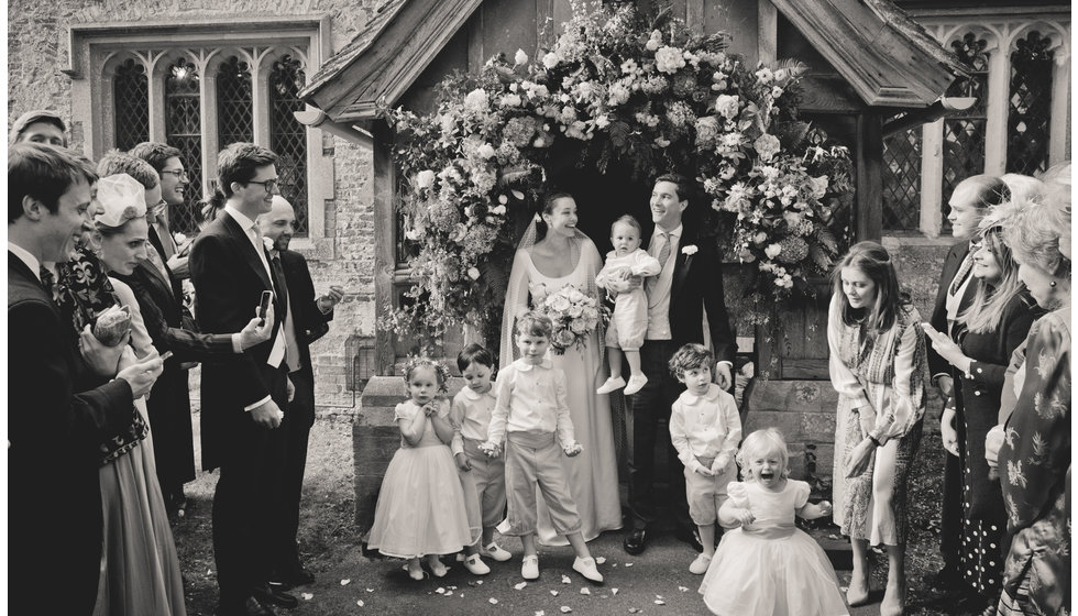 The bride and groom and their flower girls and page boys outside the Church.