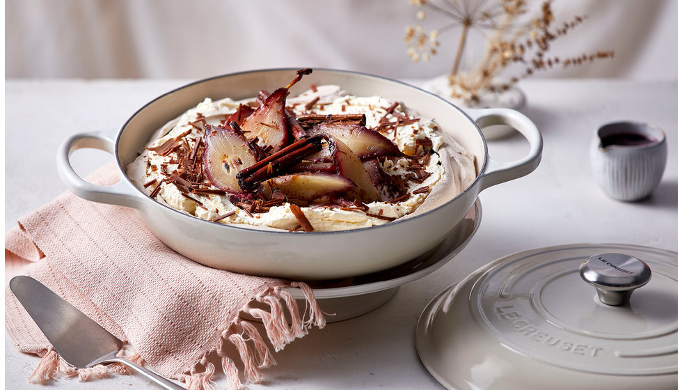 A shallow cast iron with a pavola in with poached pears.