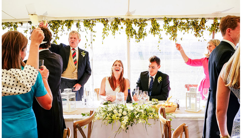 The beautiful marquee filled with beautiful natural flower arrangements.