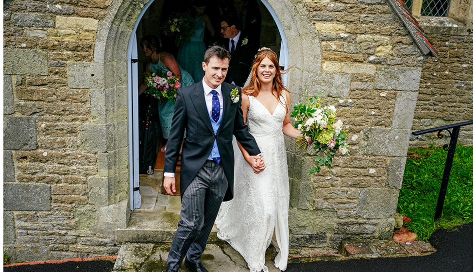 The bride and groom leave the church.