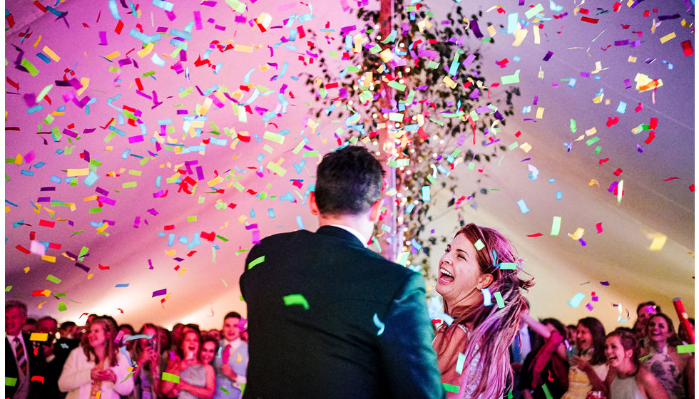 Victoria and Josh doing their first dance surrounded by confetti.