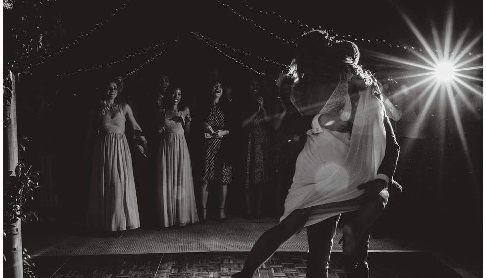 A silhouette of a couple doing their first dance.