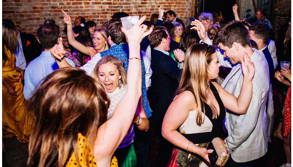 Guests on a dancefloor of the wedding of Rose and Julian Lloyd Owen.