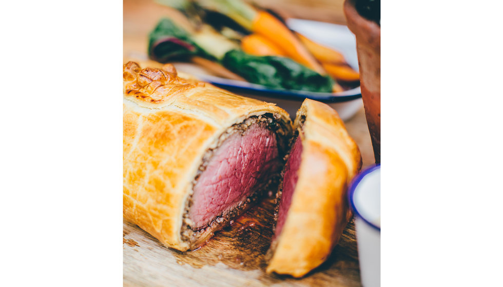 A beautiful beef wellington sliced open.