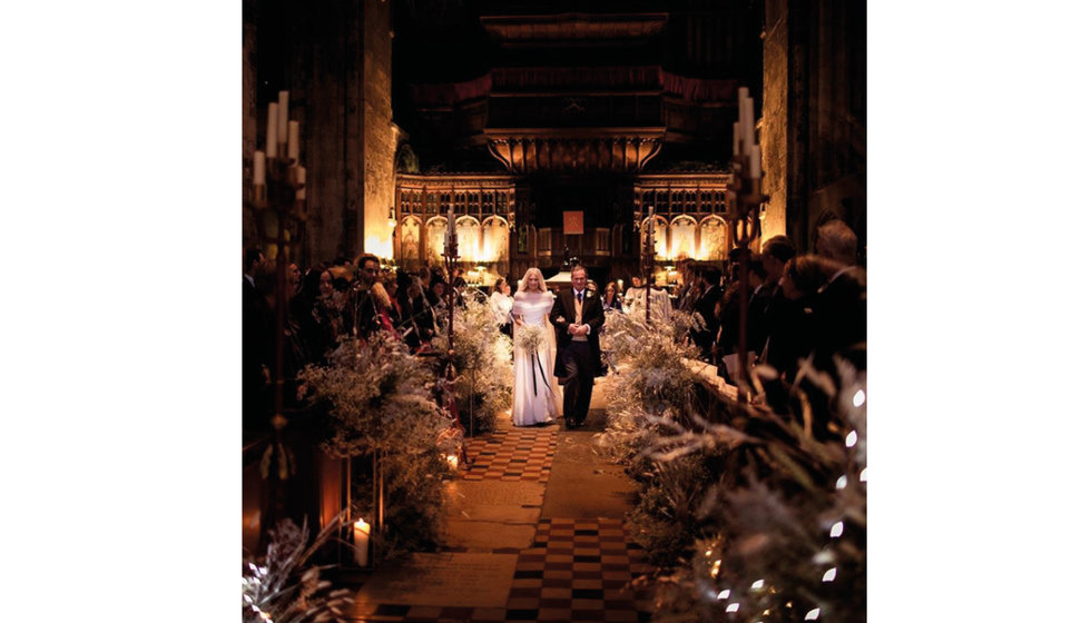 Winter blooms decorating an aisle in a church.