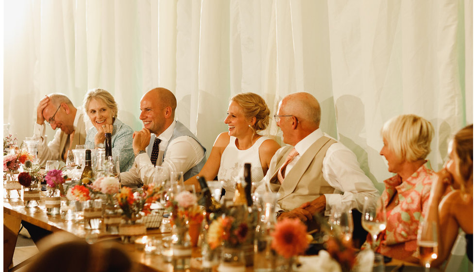 Little jars of flowers line the tables.