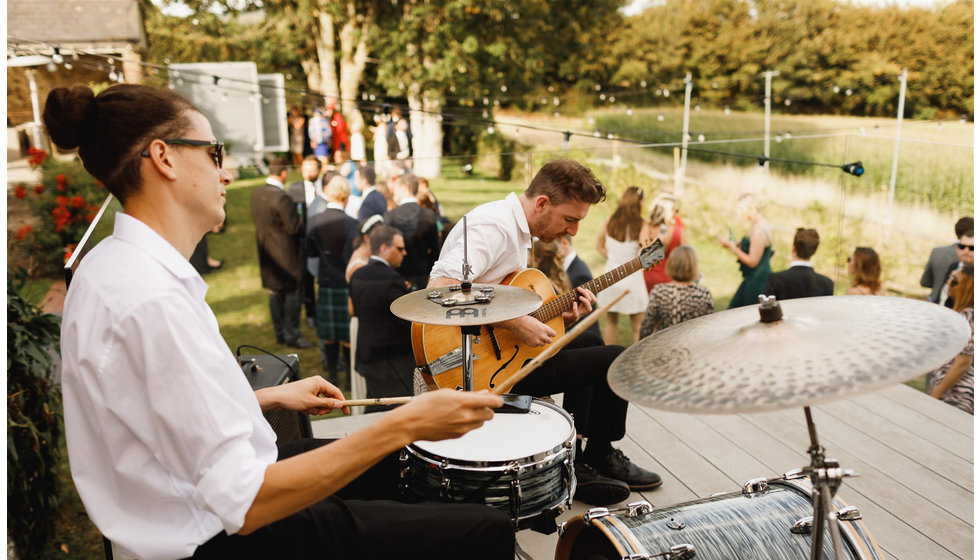 The band play outside to the guests at the reception.