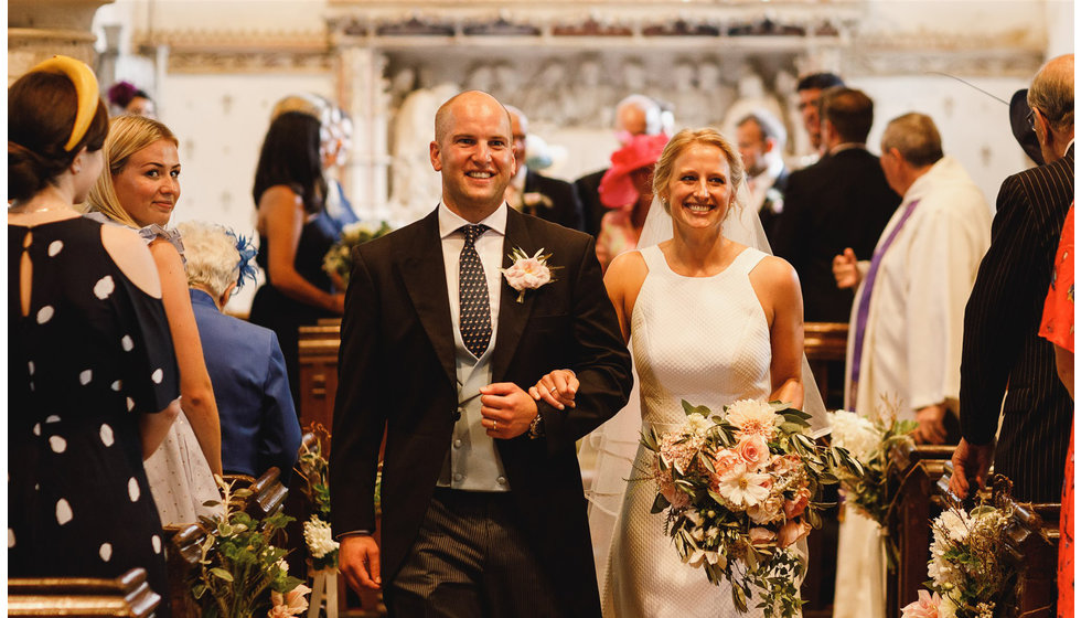 The bride and groom walking down the aisle.