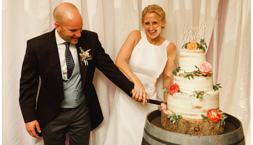 Hannah and Myles cut their wedding cake.