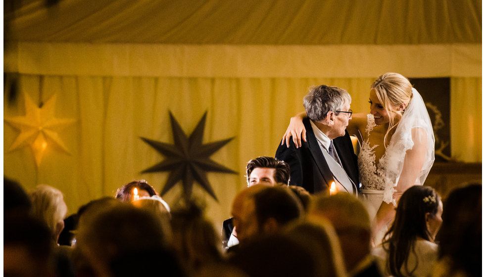 The bride hugs a family member.