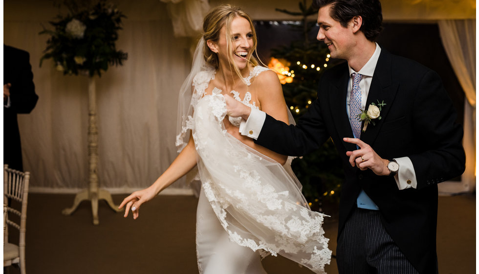 Rebecca and Sam enter the marquee holding hands.