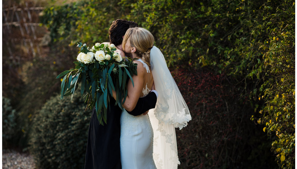 The bride and groom hugging outside the Church.