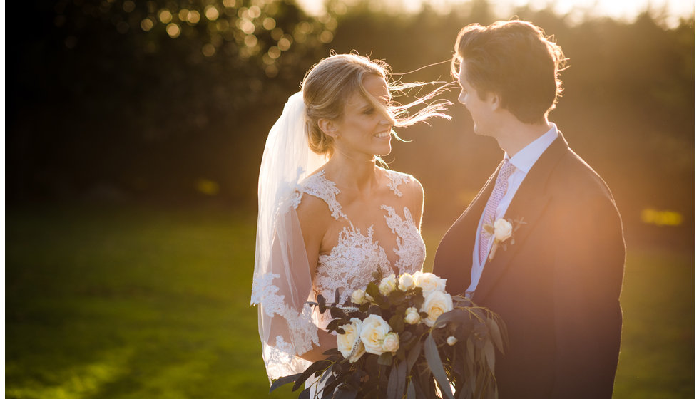 A close up of the brides wedding dress.