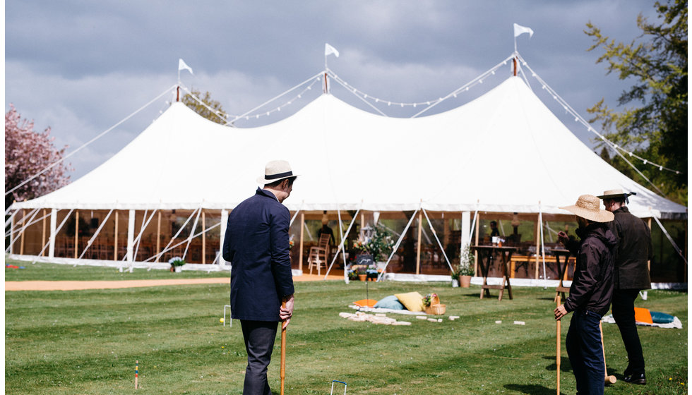 A marquee in Spring with outdoor games outside.