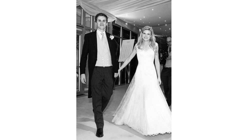 The bride and groom entering the Marquee full of their guests.