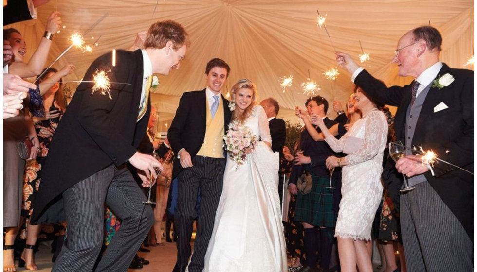 The bride and groom leaving the marquee at the end of their wedding.