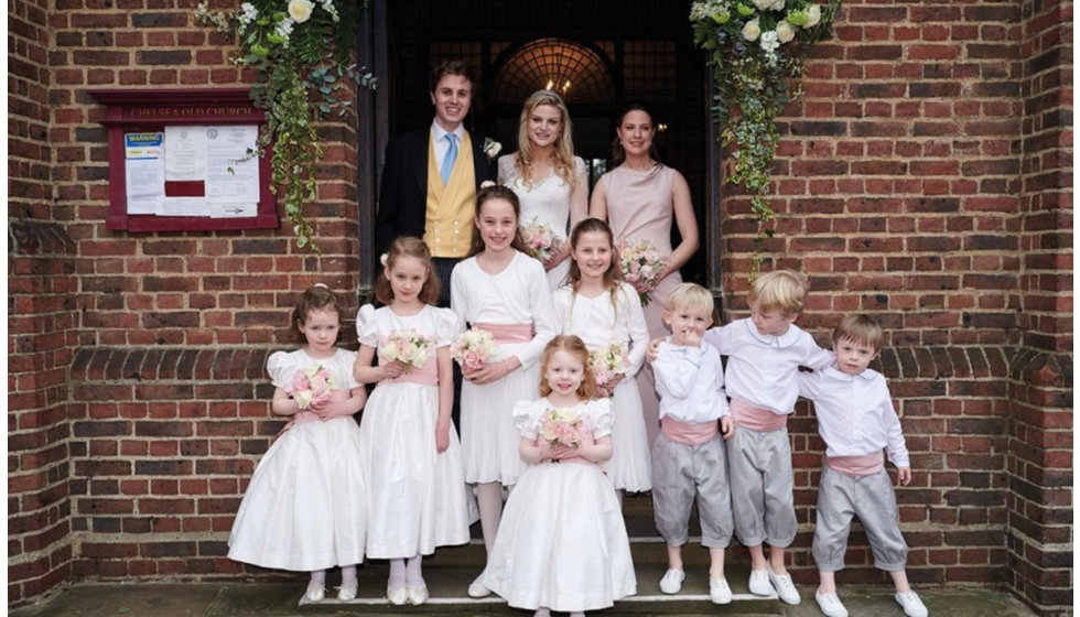 The bride, groom, maid of honor, flower girls and page boys.