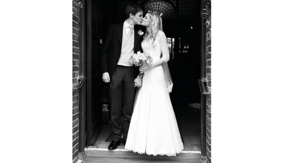 The bride and groom share a kiss outside the Church.