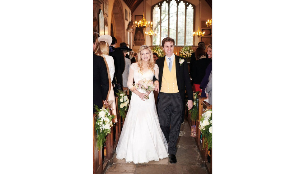 The bride and groom walk down the aisle.